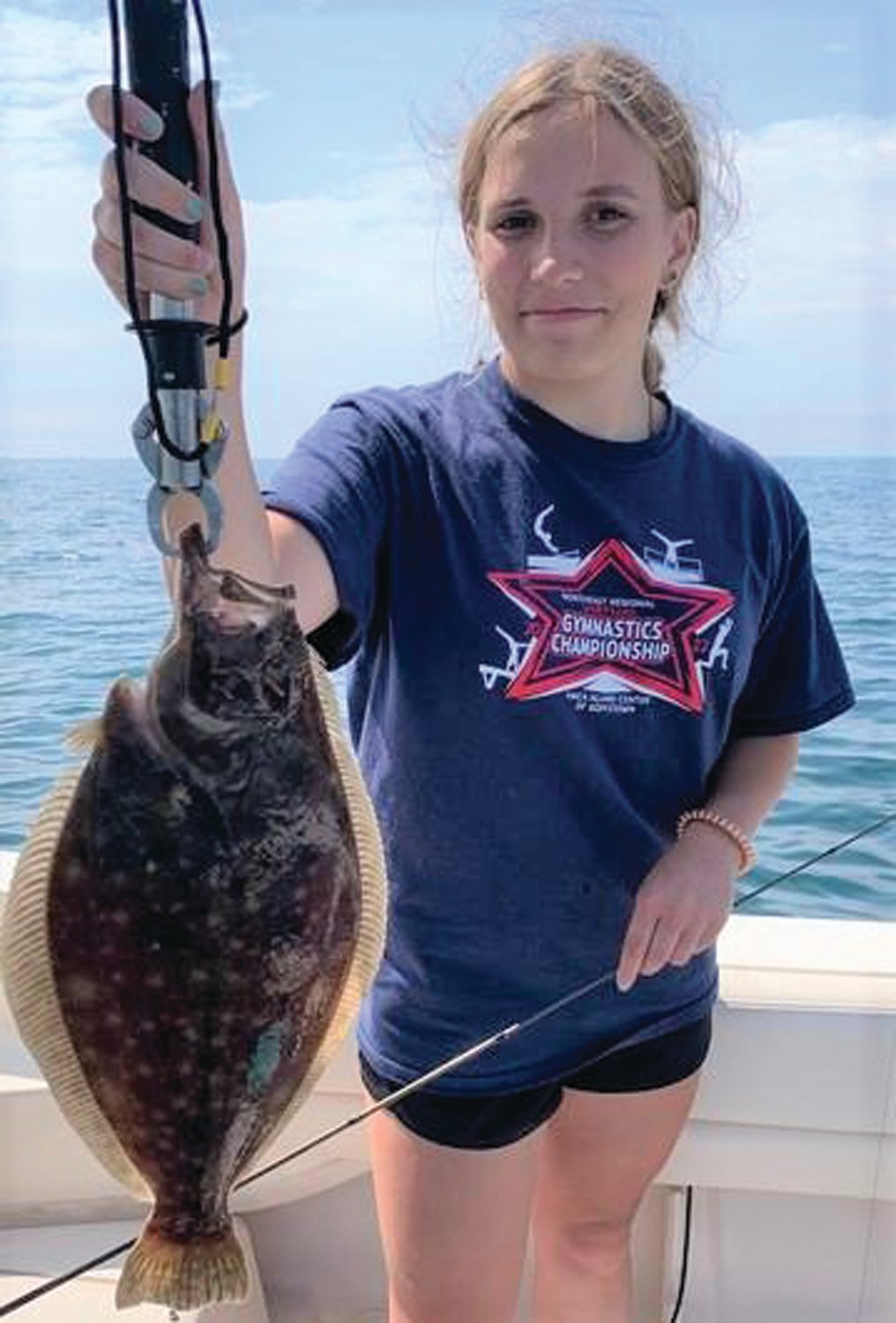 NEWPORT FLUKE: Phoebe Turner of Cumberland with a fluke (summer flounder) she caught last week when fishing with her father, Keith Turner.